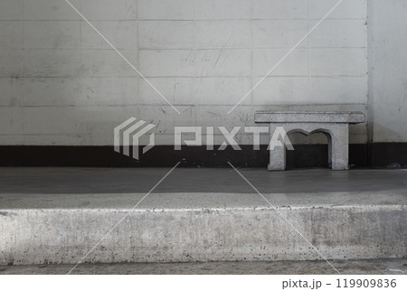 Old concrete texture wall with a old marble bench in front of it. 119909836
