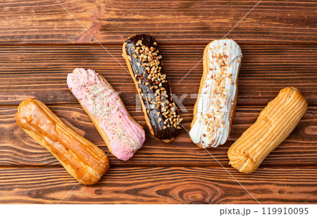 Assorted eclairs on a pastel top view Traditional French dessert Assorted eclairs on a pastel top view Traditional French dessert 119910095