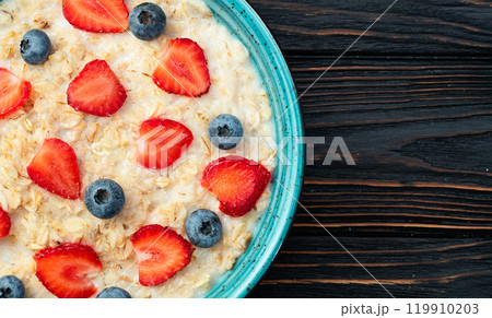 Homemade breakfast . Oatmeal with milk and berries . Top view 119910203