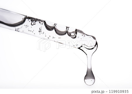 Dropper pipette with delicious serum with bubbles close-up. Dropper pipette with delicious serum with bubbles close-up. 119910935