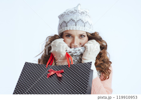 modern female in sweater, mittens, hat and scarf on white 119910953