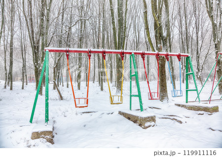 Empty swing in winter time with snow 119911116