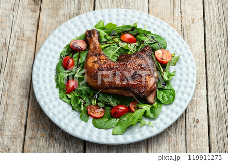 Grilled chicken legs with tomatoes and salad . Top view Grilled chicken legs with tomatoes and salad . Top view 119911273