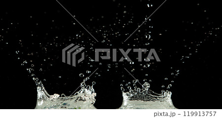 Crown water to object make curve drop explosion in ripple motion. Black background isolated. Crown Water splash on object to create shape form fluttering in droplet and wave. 119913757