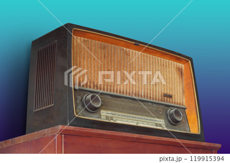 antique and old brown radio on old red wooden table, blue and green gradient wall background, object, ancient, decor, fashion, template, copy space antique and old brown radio on old red wooden table, blue and green gradient wall background, object, ancient, decor, fashion, template, copy space 119915394