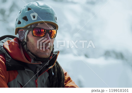Man with sun glasses is climbing in the mountains. 119918101