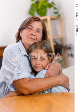 Loving grandmother and granddaughter embracing Loving grandmother and granddaughter embracing 119919033
