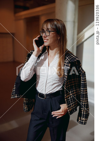 A Confident Businesswoman Poses in a Modern Office Setting That Exudes Professionalism and Style A Confident Businesswoman Poses in a Modern Office Setting That Exudes Professionalism and Style 119920386