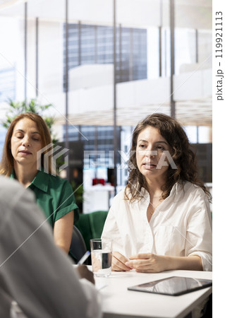 HR specialists in office determining if candidate possesses skills and experience needed to fulfil role. Employer discussing with person applying for startup internship evaluating qualifications HR specialists in office determining if candidate possesses skills and experience needed to fulfil role. Employer discussing with person applying for startup internship evaluating qualifications 119921113