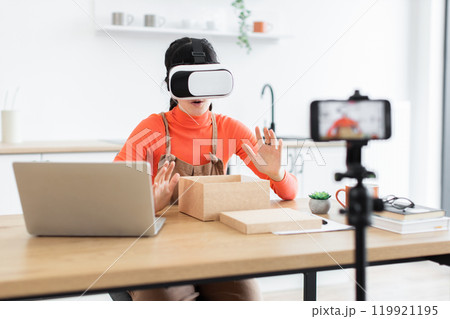 Caucasian female blogger unboxing virtual reality headset online Caucasian female blogger unboxing virtual reality headset online 119921195