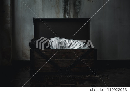 Horror ghost woman. Asian ghost horror creepy scary have hair covering face and eye lying in the old treasure chest, female makeup terror zombie face, murder, Happy Halloween day concept Horror ghost woman. Asian ghost horror creepy scary have hair covering face and eye lying in the old treasure chest, female makeup terror zombie face, murder, Happy Halloween day concept 119922058