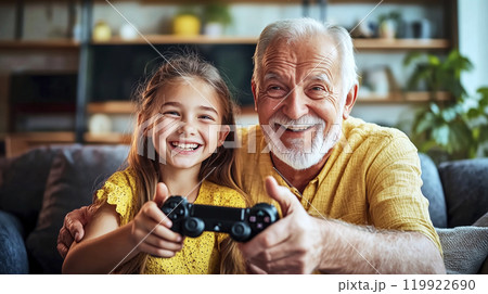 Grandfather and granddaughter having fun playing videogames at home Grandfather and granddaughter having fun playing videogames at home 119922690