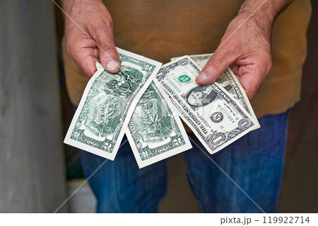Human male hands holding small dollar bills.Paper money,currency Human male hands holding small dollar bills.Paper money,currency 119922714