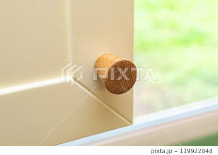 Minimalistic wooden handle on modern kitchen cabinet 119922848