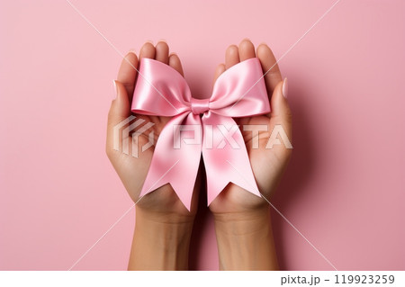 Girl holding pink bow. ideal for text placement in greeting cards, invitations, and designs 119923259