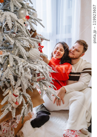 beautiful couple near christmas tree beautiful couple near christmas tree 119923607
