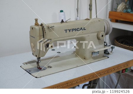 SURABAYA, INDONESIA JULY 01, 2024 - Sewing machine in the workshop. Sewing machine on the table SURABAYA, INDONESIA JULY 01, 2024 - Sewing machine in the workshop. Sewing machine on the table 119924526