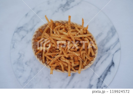 potato sticks in a rattan basket on white background. potato sticks in a rattan basket on white background. 119924572