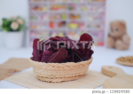 purple sweet potato chips in a rattan basket purple sweet potato chips in a rattan basket 119924580