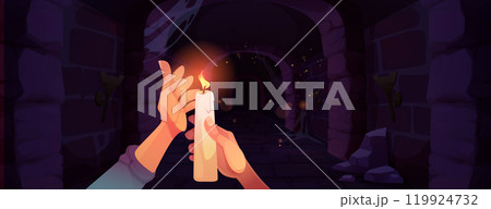 Hands holding burning candle in medieval dungeon 119924732