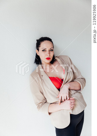 Beautiful plump brunette woman in a business suit 119925986