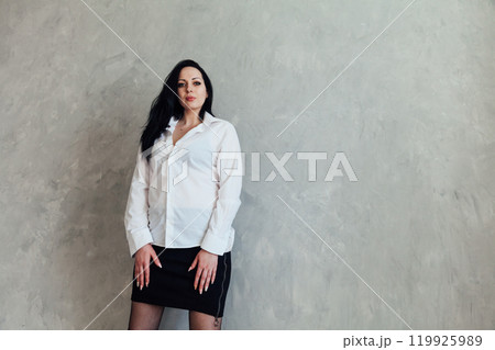Portrait of a beautiful brunette woman in a white blouse 119925989
