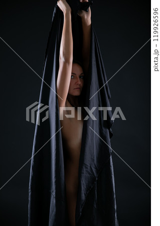 Beautiful brunette woman in black lingerie on gray background Beautiful brunette woman in black lingerie on gray background 119926596