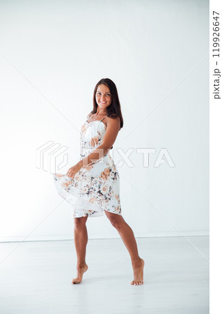 Red Young Tanned Slim Brunette Woman In White Dress Red Young Tanned Slim Brunette Woman In White Dress 119926647