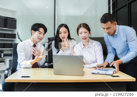 Business team working on a project in the office or reviewing and discussing a business project. 119927280