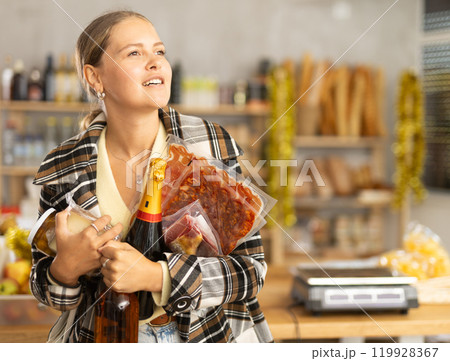 Young woman with food and champagne 119928367