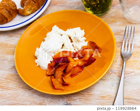 Cottage cheese with sour cream and sliced peach and croissants Cottage cheese with sour cream and sliced peach and croissants 119928664