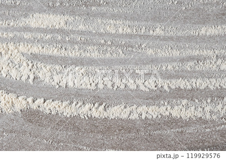 Grey cooking background of spilled wheat flour on stone background, top view. 119929576
