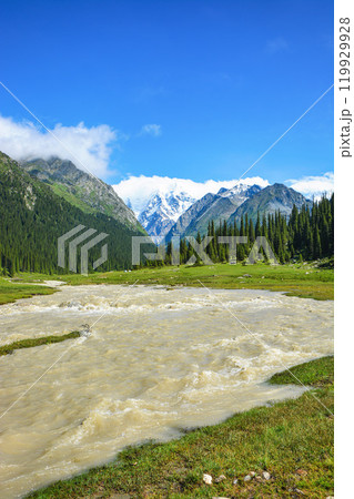 Idyllic summer landscape with hiking trail in the mountains with beautiful fresh green mountain pastures, river with reflection and forest. Terskey Alatoo mountains, Tian-Shan, Jeti-Oguz, Kyrgyzstan 119929928