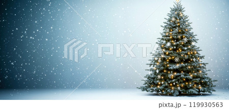 Christmas tree sparkling with lights under falling snowflakes 119930563