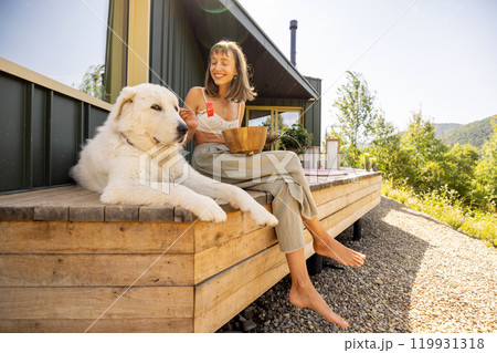 Relaxing on the Porch with a Loyal Companion 119931318