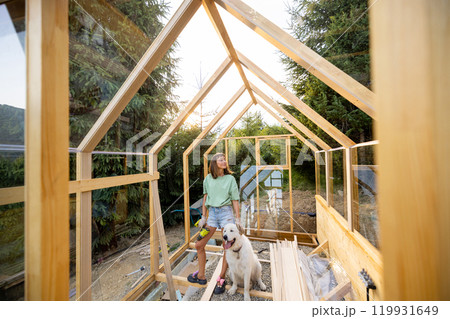Female Carpenter with Her Dog in Greenhouse Female Carpenter with Her Dog in Greenhouse 119931649