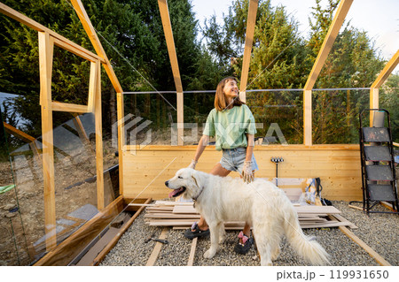 Female Carpenter Playing with Her Dog Female Carpenter Playing with Her Dog 119931650