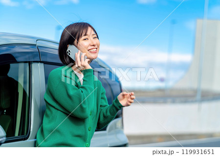 車の前で電話する女性 車のトラブルで電話する女性 車の前で電話する女性 車のトラブルで電話する女性 119931651