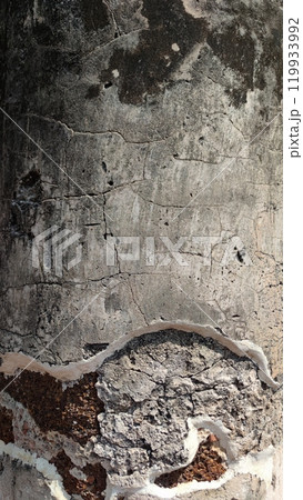 Close-up of textured concrete surface with cracks and peeling paint. 119933992