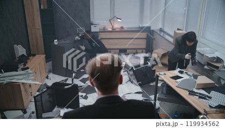 Office robbery case: Back view of male detective examining crime scene Office robbery case: Back view of male detective examining crime scene 119934562