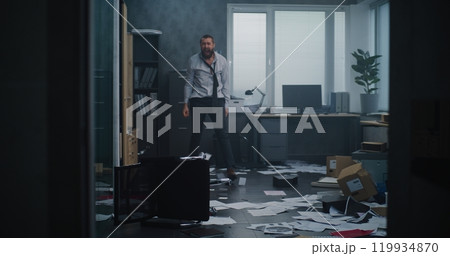 Aggressive businessman in fit of rage yells and destroys office room Aggressive businessman in fit of rage yells and destroys office room 119934870