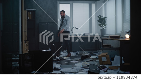 Furious businessman throwing folders and papers off the desktop, yelling, destroying office room Furious businessman throwing folders and papers off the desktop, yelling, destroying office room 119934874