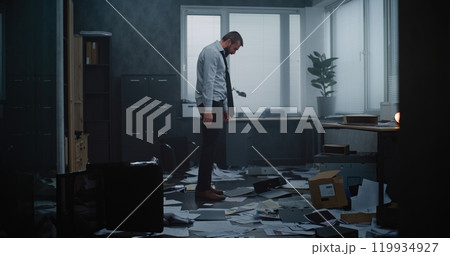 Furious businessman throwing folders and papers off the desktop, yelling, destroying office room Furious businessman throwing folders and papers off the desktop, yelling, destroying office room 119934927