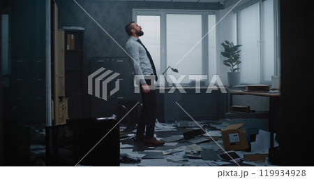 Furious businessman throwing folders and papers off the desktop, yelling, destroying office room 119934928