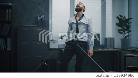 Furious office worker throws boxes and papers off the shelves, destroys office room, screams 119934960