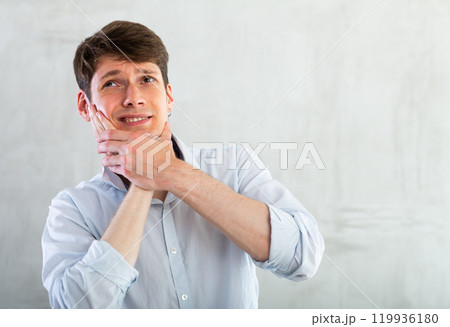 Young guy holding his cheek with toothache 119936180