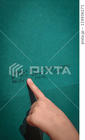 A boy reading the evacuation plan on the wall in braille. Close-up of a child reading braille. The concept of inclusiveness. World Sight Day. World Braille Day A boy reading the evacuation plan on the wall in braille. Close-up of a child reading braille. The concept of inclusiveness. World Sight Day. World Braille Day 119936271