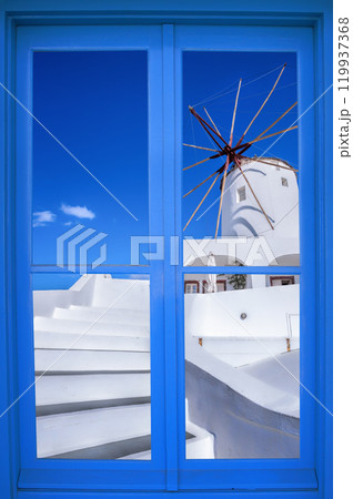 Oia village with windmill through blue window on Santorini island in Greece Oia village with windmill through blue window on Santorini island in Greece 119937368