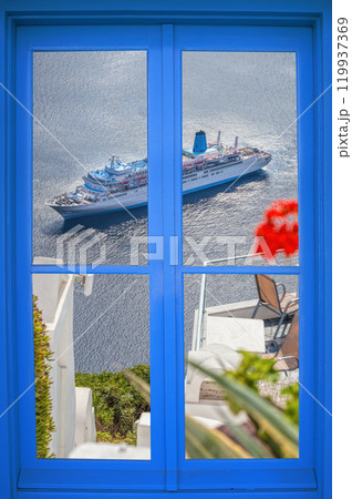 Oia village with tourist boat through blue window on Santorini island in Greece 119937369