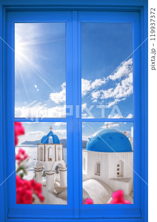 Oia village with churches through blue window on Santorini island in Greece 119937372